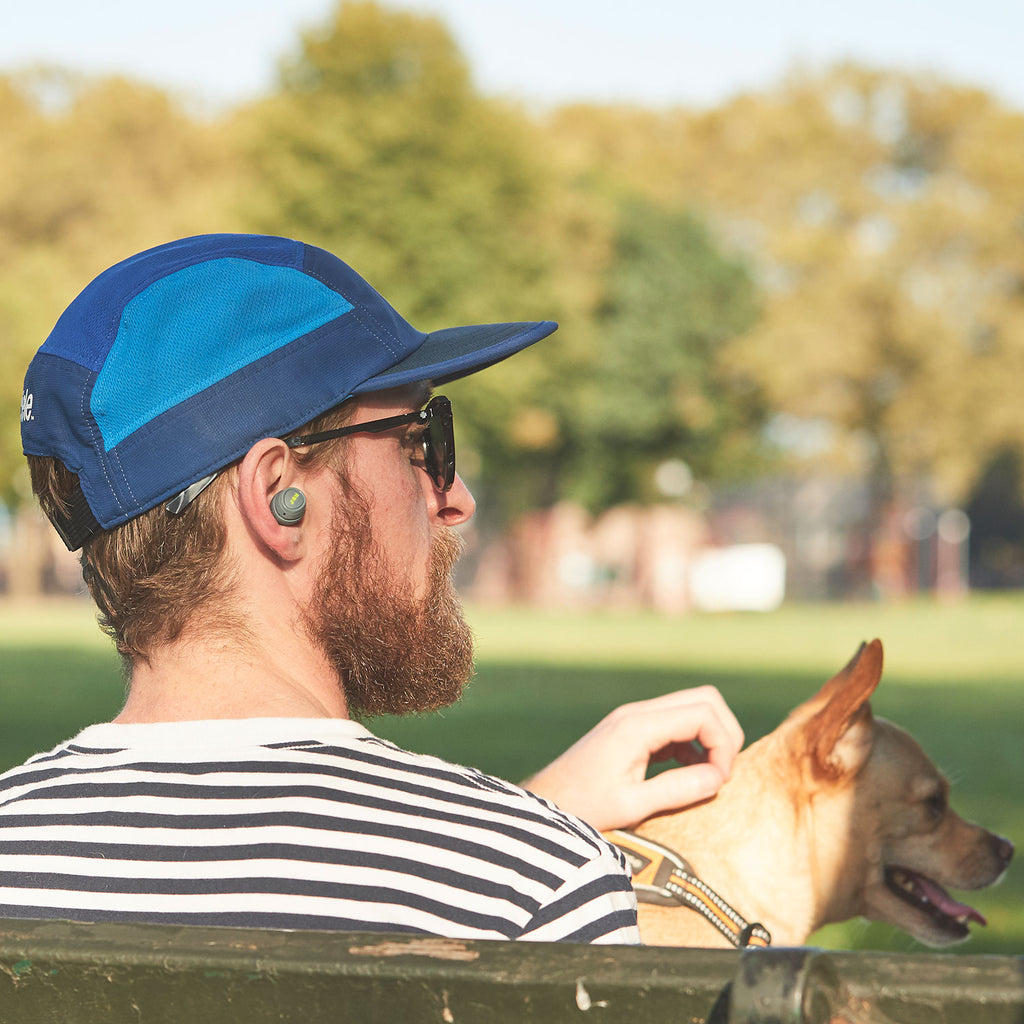 Man wearing Jam Audio Live Free Truly Wireless Earphones Grey next to dog 