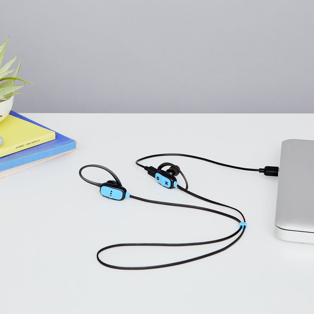 Jam Audio Live Large Wireless Bluetooth® Black Earbuds plugged into laptop