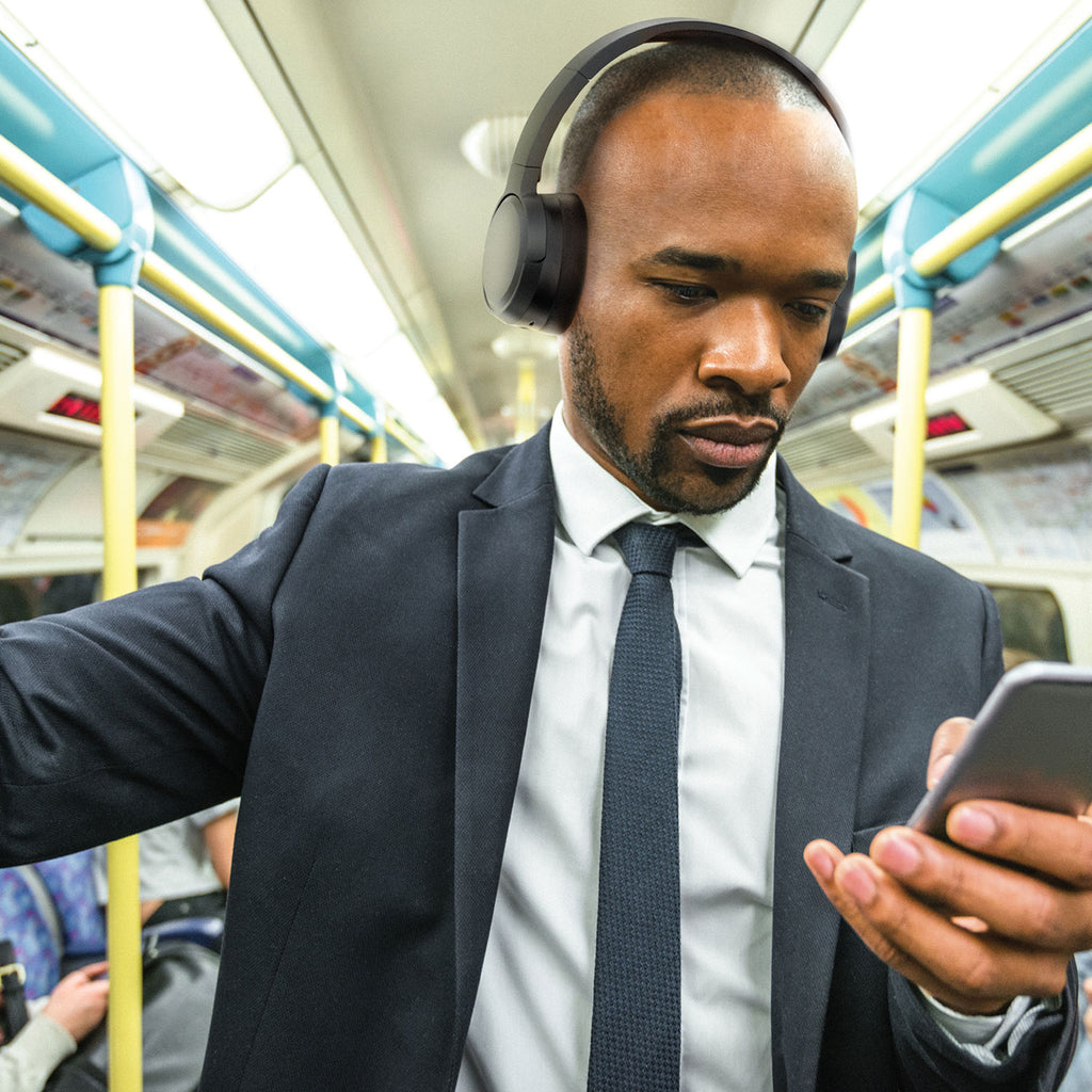 Man wearing Jam Audio Travel ANC Wireless Headphones on train