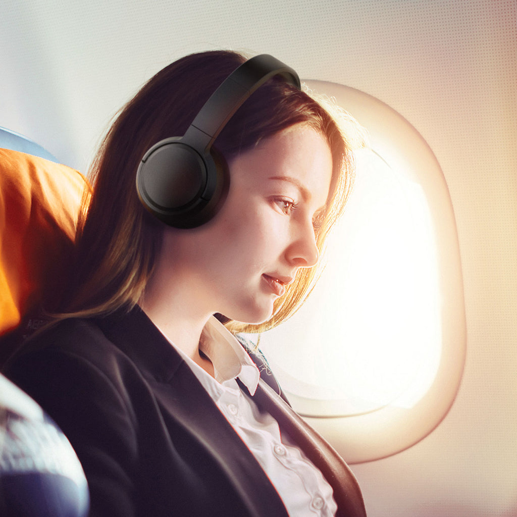 Woman wearing Jam Audio Travel ANC Wireless Headphones on plane